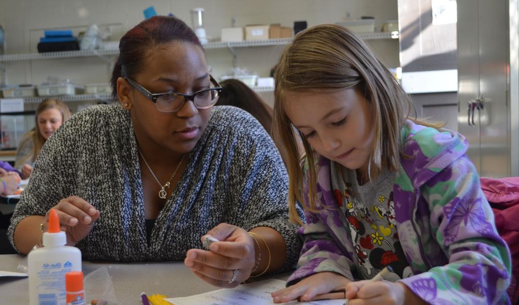 An education student working with a child in an on-campus program.